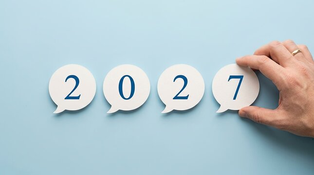 Hand placing the final number to complete the year two thousand twenty seven