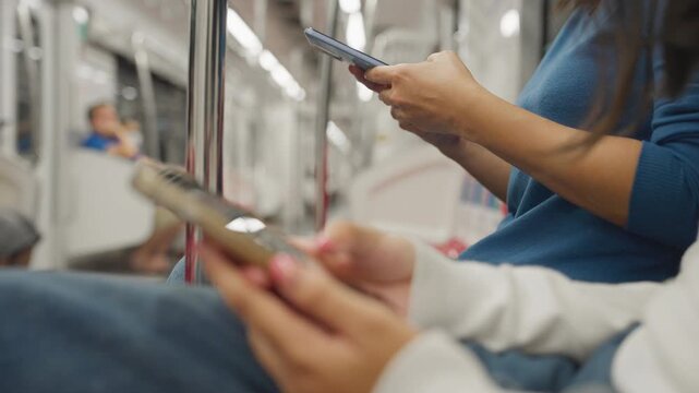 Close up hand of young woman using mobile phone at skytrain.