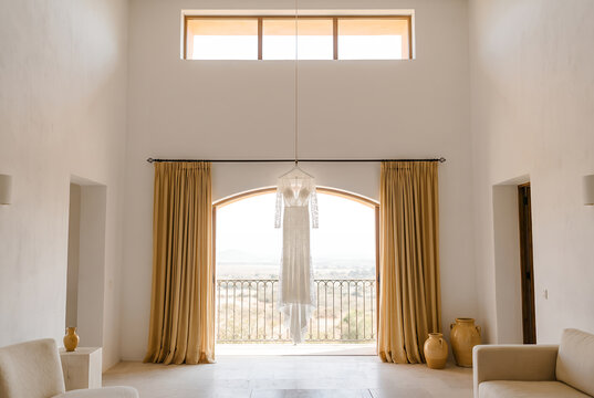 Mediterranean living room with arched balcony door and curtains