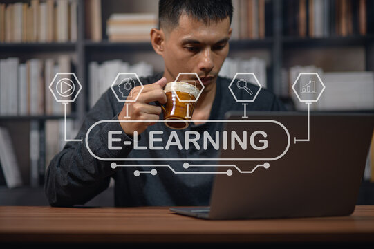 Young Man Drinking Coffee During Online Learning Session in Modern Library