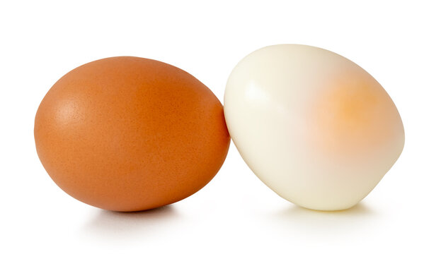 A stack of unpeeled cooked or boiled chicken egg with egg yolk isolated on white background with clipping path