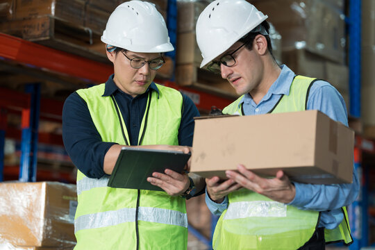 Close up of warehouse worker discussing, collaborating on logistics management and inventory operations in distribution center