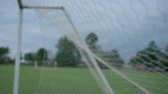 Close Up of Soccer Goal Net on Empty Green Football Field Outdoors