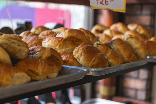 Chocolate Filled Croissants on an Aluminum Tray in a Bakery