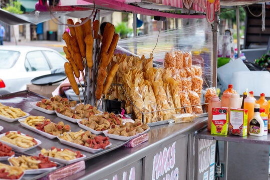 Mexican Street Food Stall Selling Fries, Sausages, Duritos, and Corn Dogs