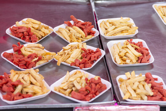Plates of French Fries and Fried Sausages at a Mexican Street Food Stall
