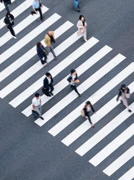 People walking on crosswalk Aerial view People lifestyle Downtown district Business economic concept Blur City street scene