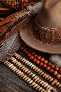 Thanksgiving Elements with Close-up Rustic Hat, Feather Arrangement and Wooden Beads for Cultural Holiday Displays and Craft Backgrounds