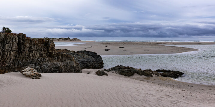 moody late afternoon light falling upon Grotto Lagoon and rocky coastline, Hermanus, South Africa