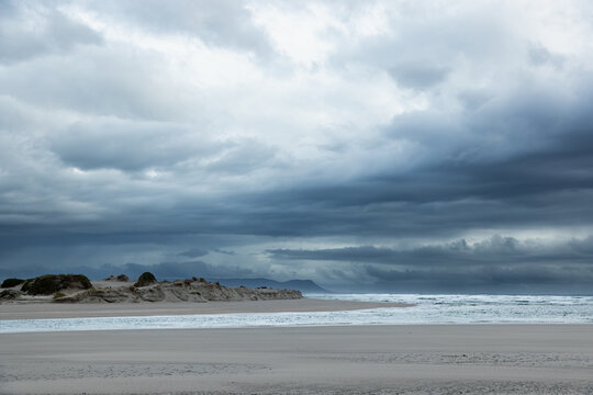 moody late afternoon light falling upon Grotto Lagoon and rocky coastline, Hermanus, South Africa