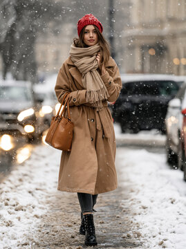 Stylish Woman Walking on Snowy City Street
