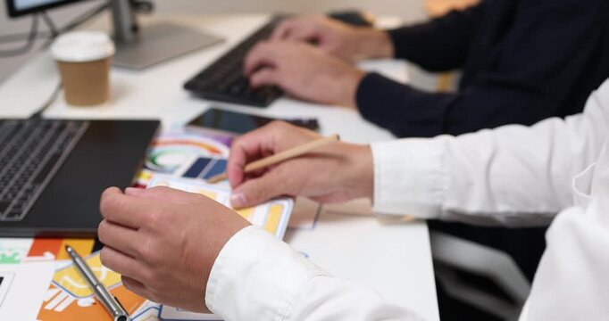 UX UI design and user experience development, featuring creative professionals collaborating on interface layouts, reviewing design prototypes, and refining visual elements to create intuitive.