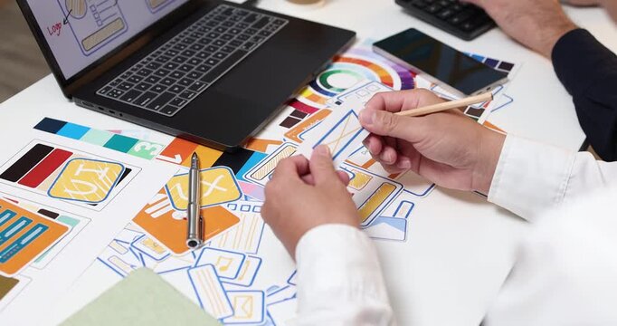 UX UI design and user experience development, featuring creative professionals collaborating on interface layouts, reviewing design prototypes, and refining visual elements to create intuitive.
