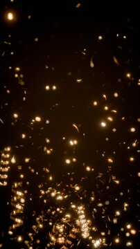 Gold confetti and streamers bursting upward with bokeh vertical video