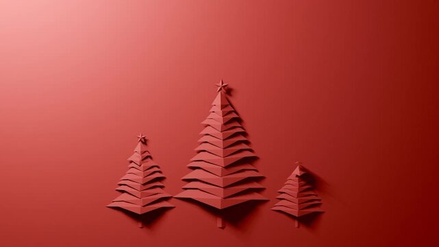 Three red paper Christmas trees assembling with copy space