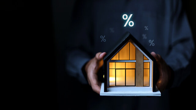Home loan and mortgage interest rate concept with house model, financial planning, real estate investment and property finance