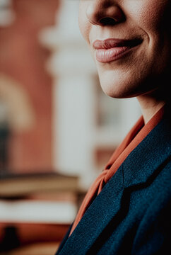 Close-up of a smiling woman in a professional blazer