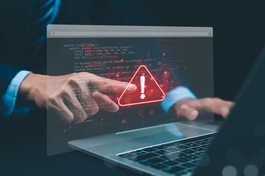 Cybersecurity risk warning on a laptop screen as hands interact with digital code, highlighting software vulnerabilities, system errors, data protection, and information security.