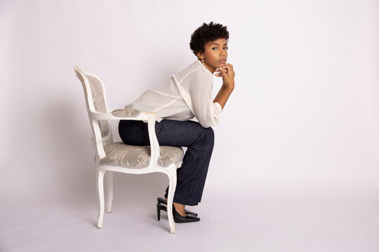 Hispanic woman sitting thoughtfully