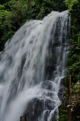 Waterfall cascading through lush forest in Thailand © Emad Aljumah