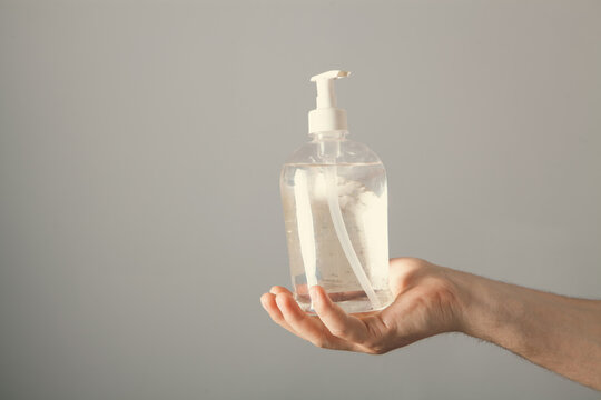 Hand sanitizer gel dispenser in the hands of a man
