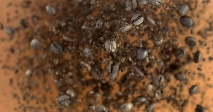 Ground coffee beans falling in slow motion 1000 fps on red background