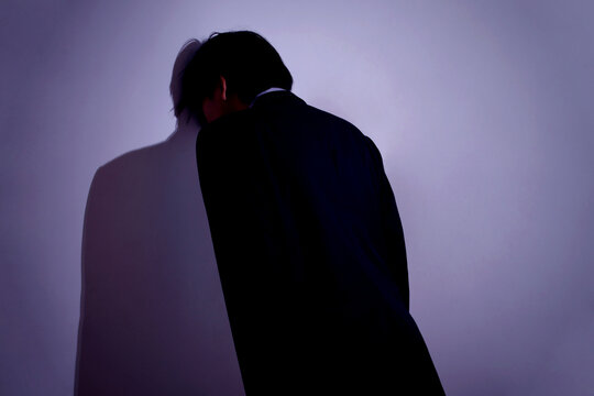 Stressed Businessman Leaning Head Against Wall Showing Frustration and Exhaustion