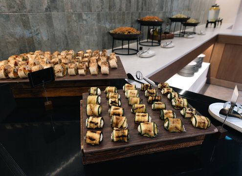 Grilled zucchini rolls with cheese filling served on a catering buffet display