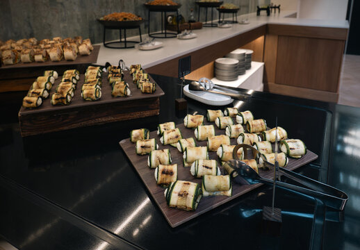 Grilled zucchini rolls with cheese filling served on a catering buffet display close-up