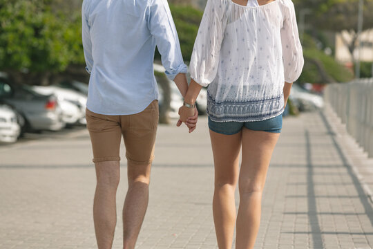 Caucasian couple walking on the promenade on a sunny day