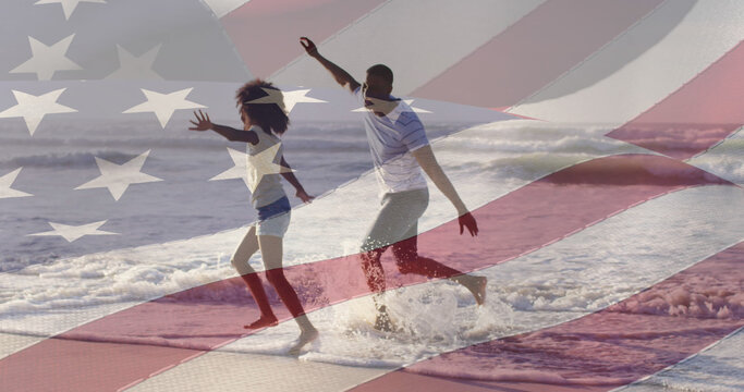 Image of flag of united states of america over african american father and daughter on beach