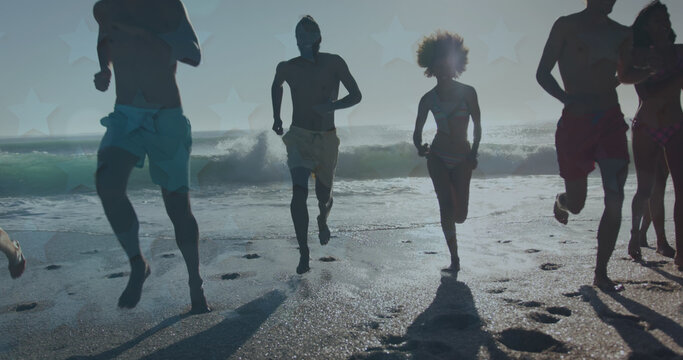 Image of stars over diverse friends running on beach