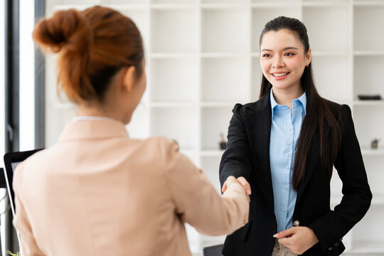 Asian Businesswomen Handshaking in Office Meeting Room