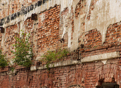 Weathered brick wall shows signs of age and decay