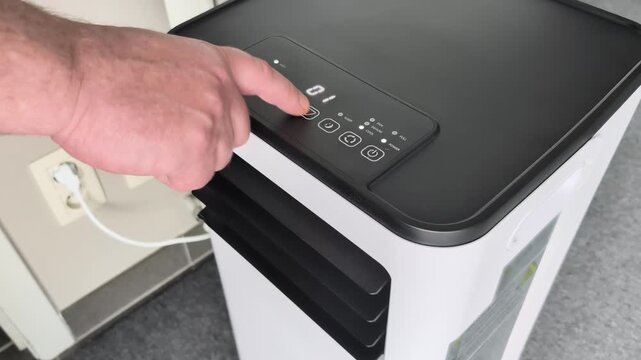 Setting timer on portable room air conditioner for better cooling