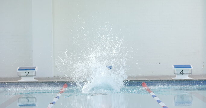 Swimmer making a splash in an indoor pool