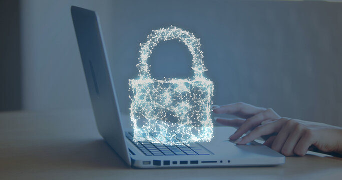 Image of security padlock, cloud icon over mid section of businesswoman using laptop at office