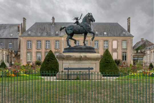Mortagne-Au-Perche, France - 10 09 2026: View  the statue of Metamorphosis of Pierre Bouchare, rear facade of H&ocirc;tel Grestien de Galais and cloudy sky background