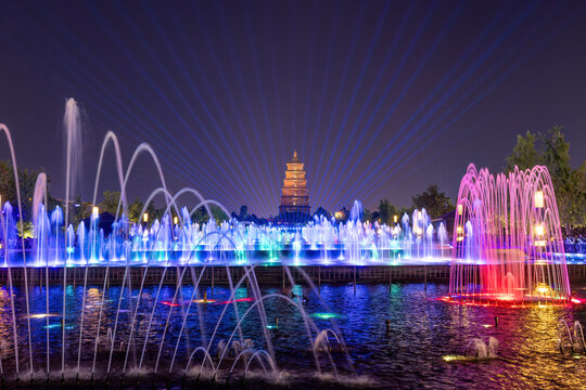 A colorful fountain and light show in front of the Giant Wild Goose Pagoda, an ancient Tang Dynasty structure in Xi'an, China
