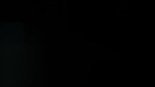 Quick white flash transition starting from black with small anamorphic lens flare and oval bokeh, flooding the frame with creamy white light, overlay for video editing and cuts