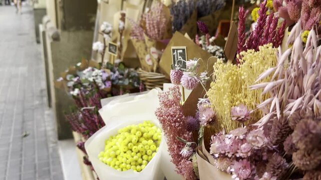 A flower shop window with dried flowers: lavender, strawflower, statice, glixia and globe amaranth.