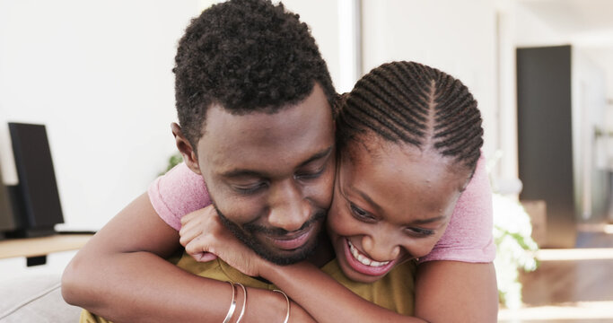 Happy african american couple embracing at home