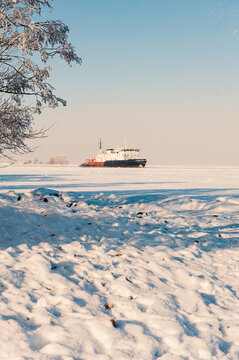 Winter shipping. Big cargo ship in frozen sea fairway