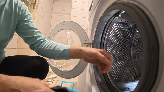 Side View of Unloading Clothes and Closing Washer Door