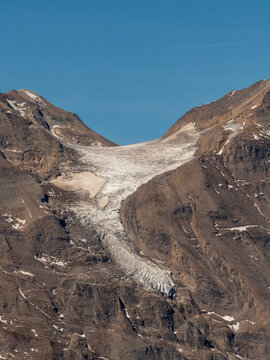 Pasterze glacier melting between rocky peaks in the austrian alps
