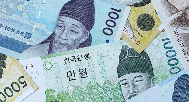 South Korean won money bills in pile on table. South Korea KRW currency cash close up