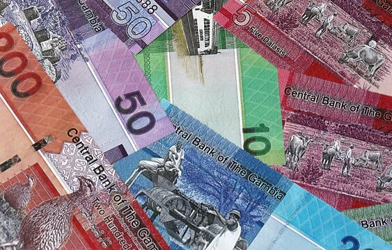 Gambian dalasi money bills in pile. Big amount of Gambia GMD currency cash close up