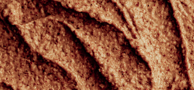 Chocolate ice cream with nuts and banana, texture. Chocolate smoothie cocktail close-up. Nut paste as a background.