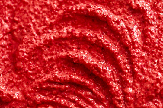 Red berry yogurt ice cream. Fresh fruit smoothie with strawberries, raspberries, pomegranate and red currants. Ice cream texture. Delicious sweet dessert close-up as a background.
