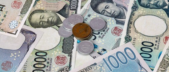 Japanese yen money notes and coins on table. Japan cash bills of JPY currency close up © Marharyta